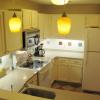 Kitchen showing range/oven, microwave and full-size refrigerator