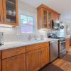 Kitchen showing sink, dishwasher, gas range, pot rack