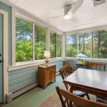 Sun drenched porch with dining room seating.