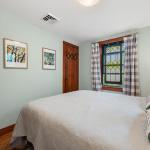 Primary bedroom has a stained glass window for privacy out to the patio.