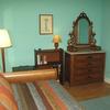 Bedroom / Sitting Room with trundle bed that opens to King size, desk/bookcase, antique dresser, trunk and cozy appointments